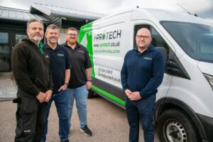 i-Protech core team members in front of a van